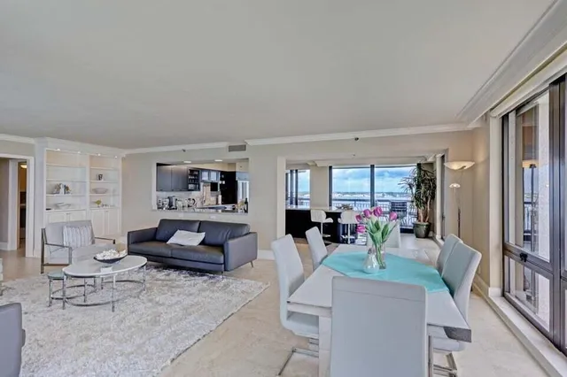 a living room with fireplace furniture and a large window