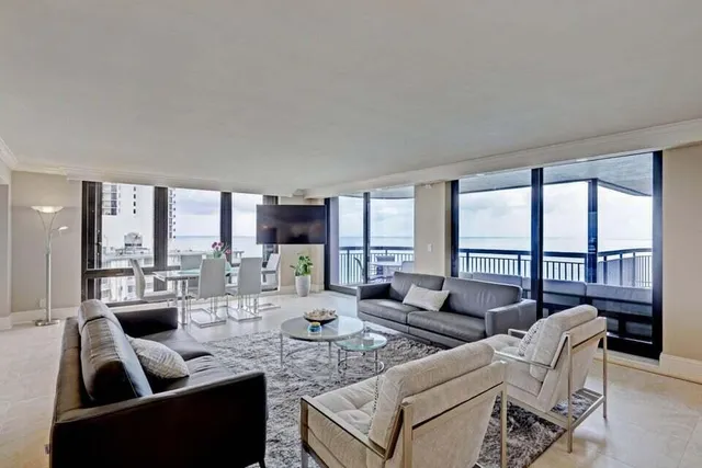 a living room with furniture and a large window