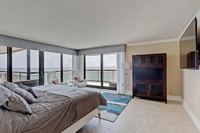 a bedroom with a bed and a large window