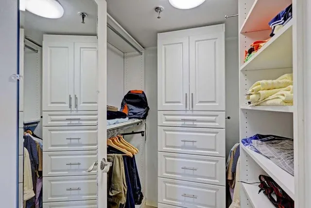 a bedroom with a bed and large window