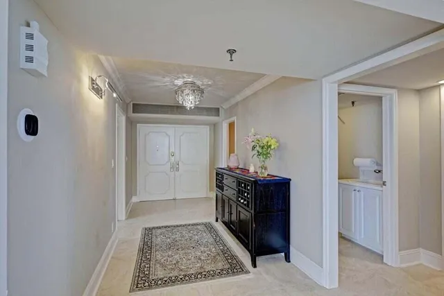a view of entryway with livingroom and chandelier
