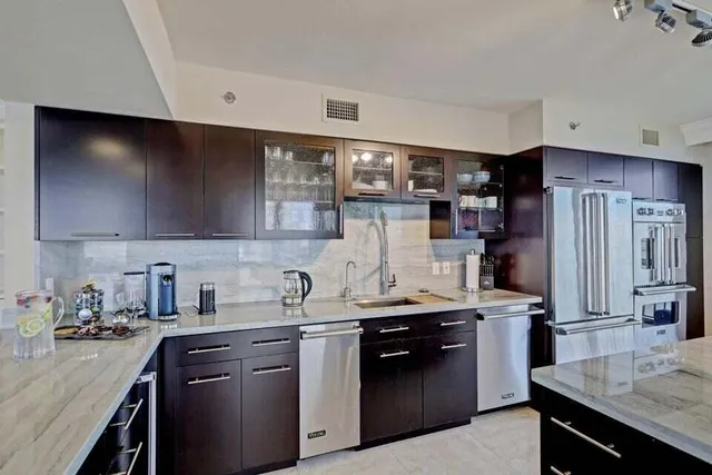 a kitchen with stainless steel appliances a sink stove and refrigerator