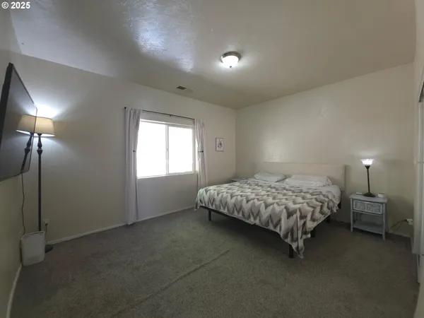 a bedroom with a bed and a lamp