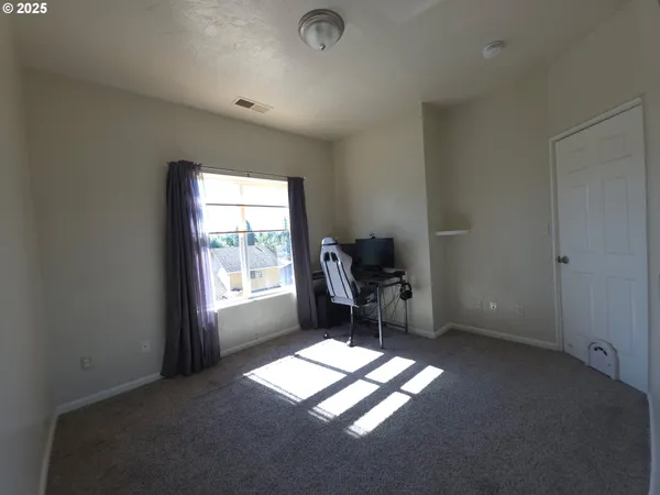 a workspace room with furniture and windows