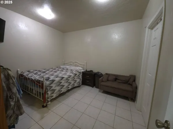 a bedroom with a bed and a dresser in it