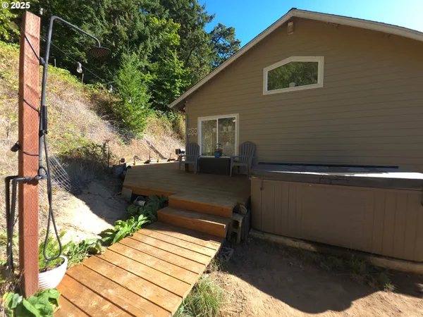 a view of backyard with a deck