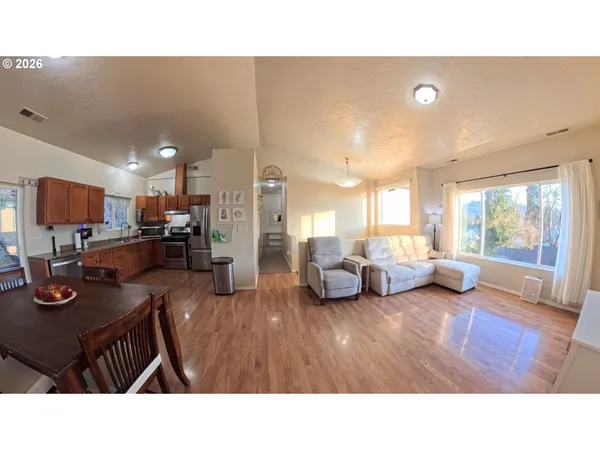 a living room with furniture a flat screen tv and a large window