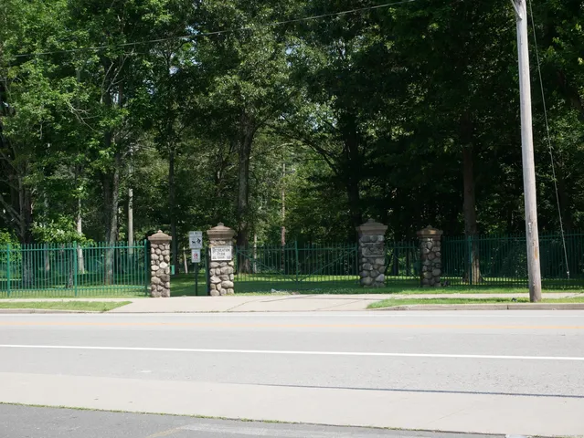 a view of a house with a backyard and a trees