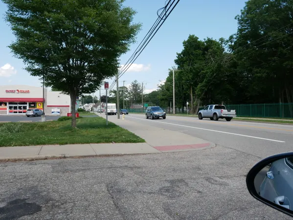 a park view with street sign board and trees