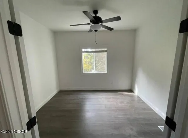 a view of an empty room and a window