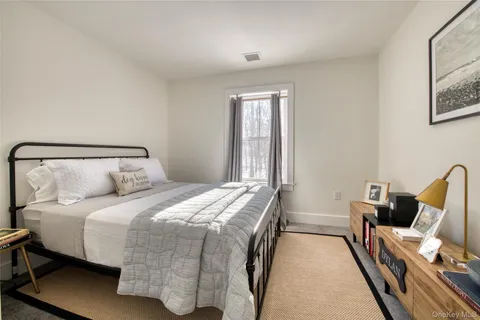 a bedroom with a bed and a chair