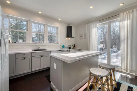 a kitchen with a sink stove and chairs