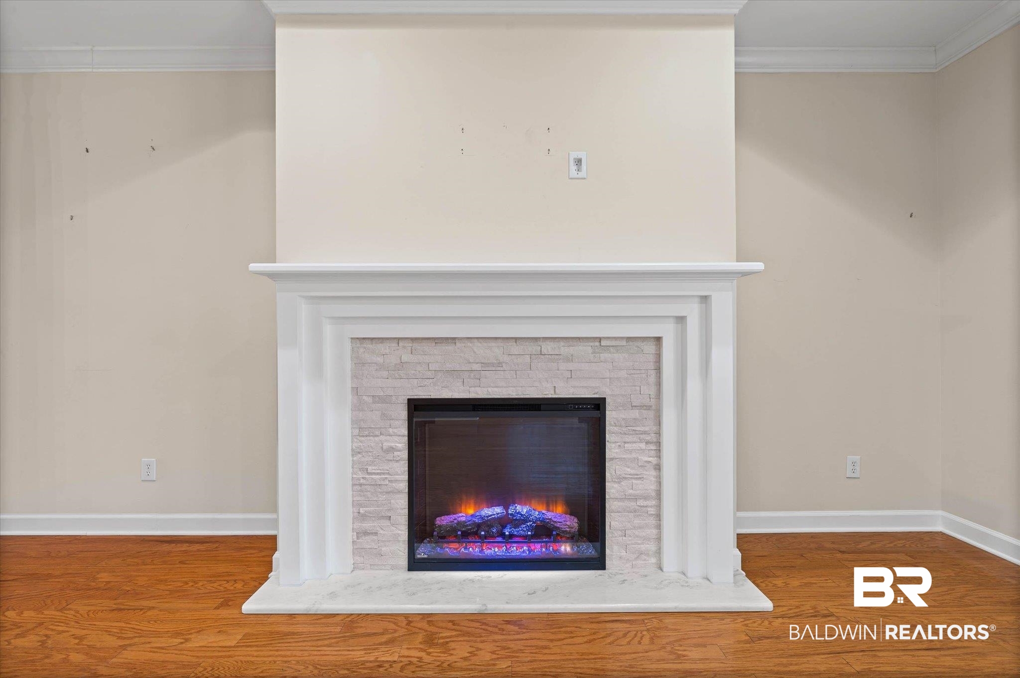 1003 Weatherby Street South Saraland, AL 36571 - Photo 7 of 31 Detailed view of crown molding, a stone fireplace, and wood finished floors