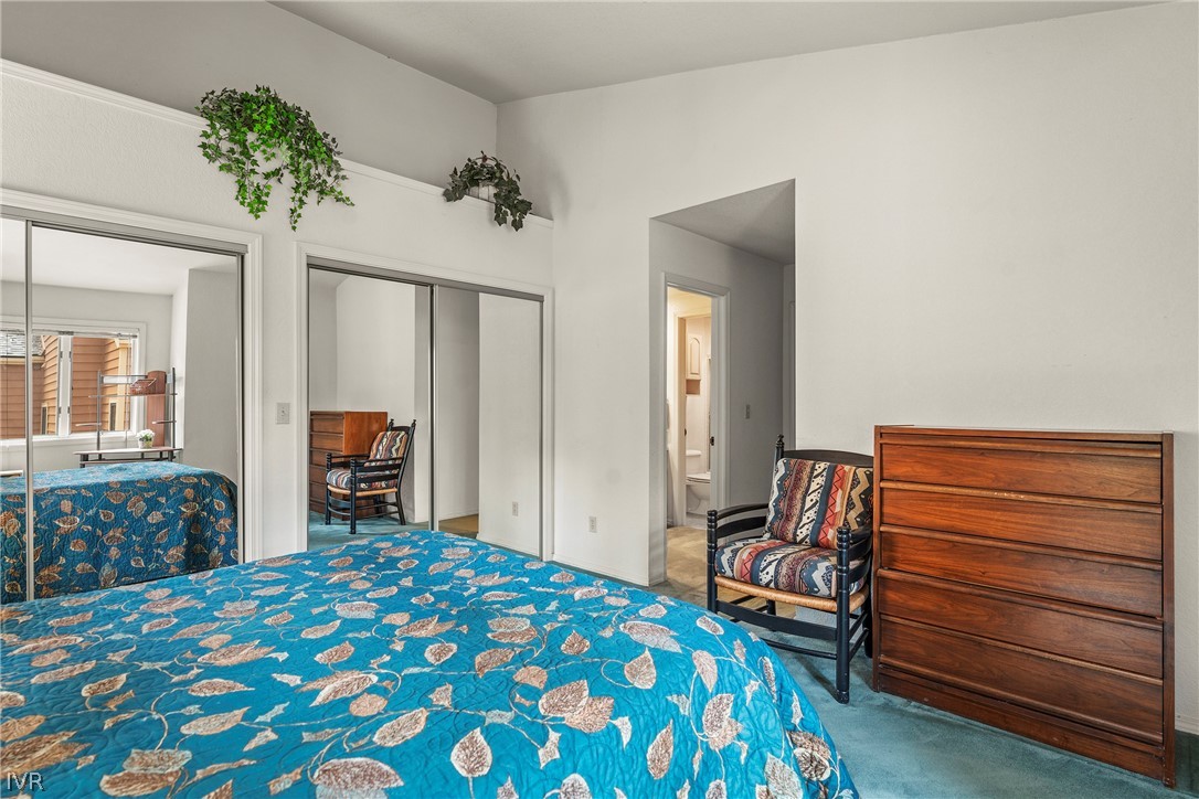 947 Incline Way, Unit 183 Incline Village, NV 89451 - Photo 13 of 37 a bedroom with a bed and a chandelier