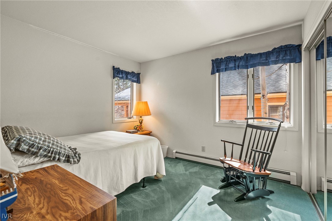 947 Incline Way, Unit 183 Incline Village, NV 89451 - Photo 15 of 37 a bedroom with a bed chair and two windows