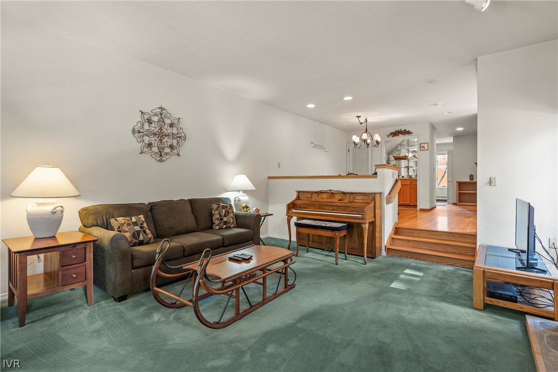 947 Incline Way, Unit 183 Incline Village, NV 89451 - Photo 3 of 37 a living room with furniture a piano and a fireplace