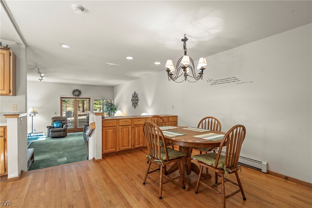 947 Incline Way, Unit 183 Incline Village, NV 89451 - Photo 9 of 37 a view of a dining room with furniture a chandelier and wooden floor