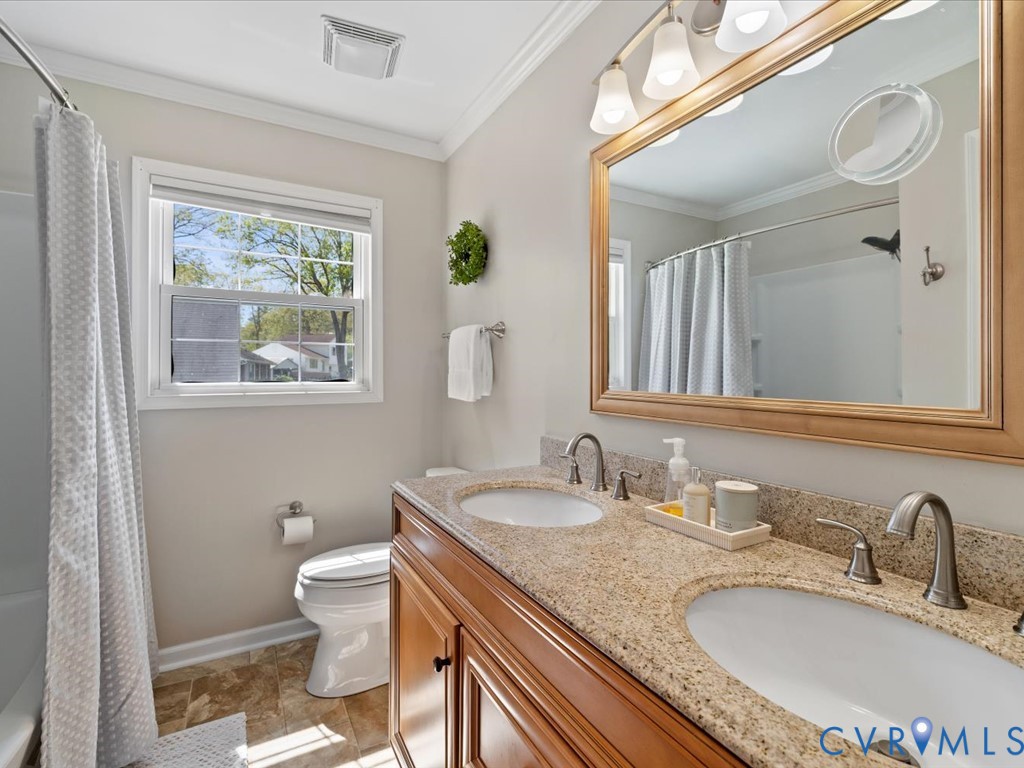 1455 Robindale Road Richmond, VA 23235 - Photo 14 of 29 a bathroom with a granite countertop toilet a sink and a mirror