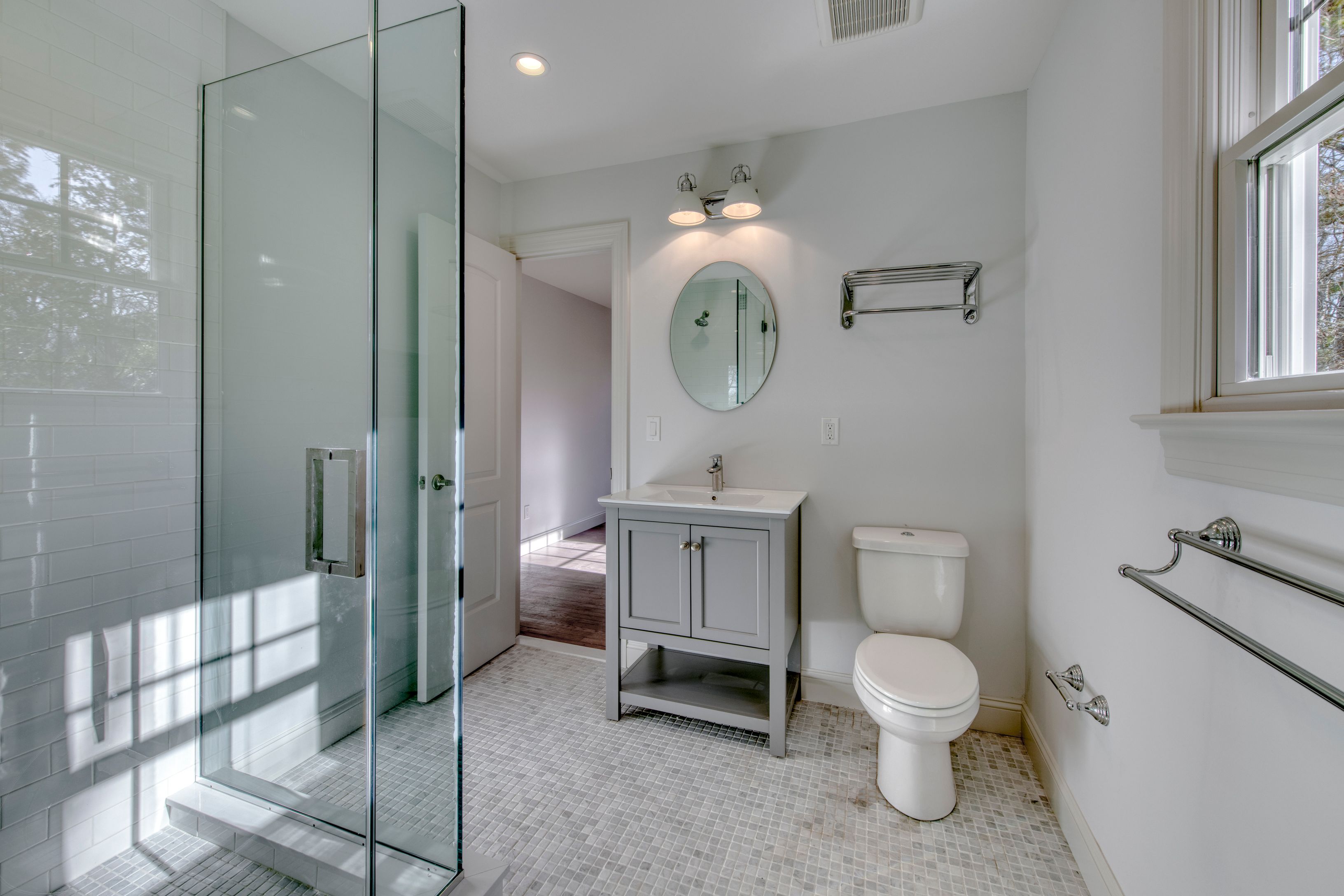 134 Beach Road Westhampton Beach, NY 11978 - Photo 9 of 16 a white toilet sitting next to a bathroom sink