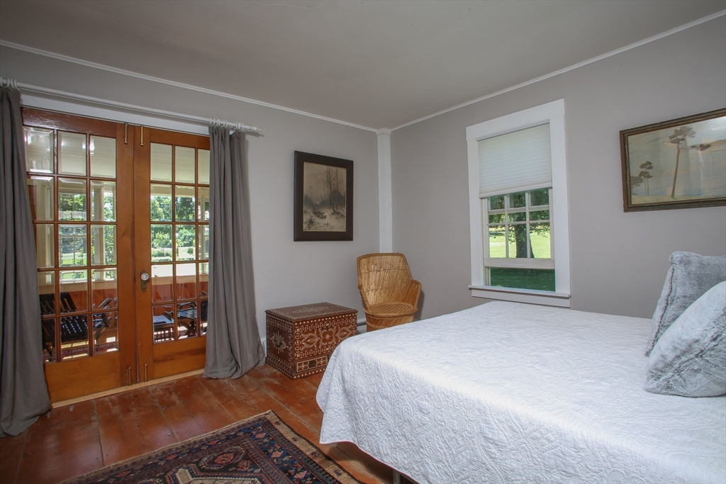 5 State Farm Road Heath, MA 01340 - Photo 19 of 42 a bedroom with a bed and wooden floor