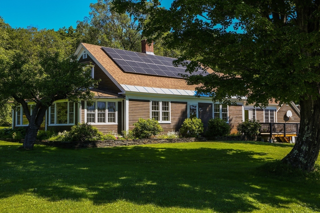 5 State Farm Road Heath, MA 01340 - Photo 2 of 42 a front view of a house with a garden