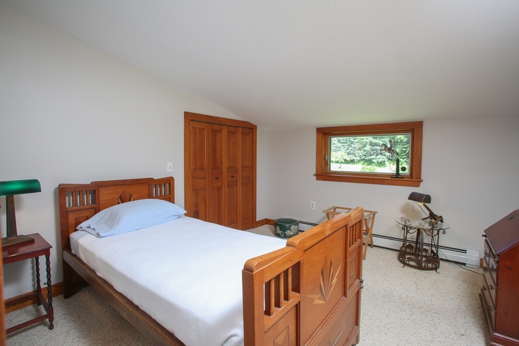 5 State Farm Road Heath, MA 01340 - Photo 23 of 42 a bedroom with a bed and a dresser in it