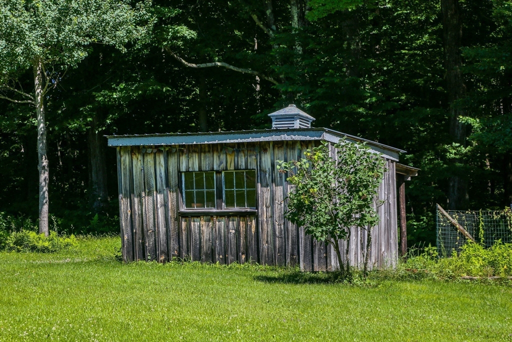 5 State Farm Road Heath, MA 01340 - Photo 33 of 42 a view of a backyard with a small cabin