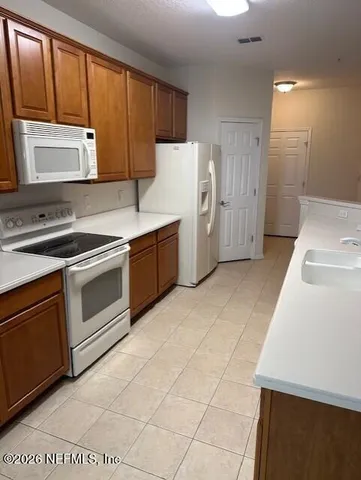 a kitchen with stainless steel appliances a stove sink and cabinets