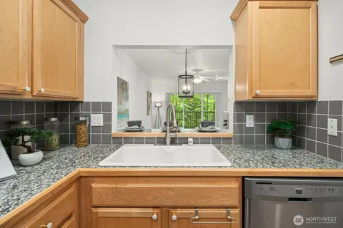 a kitchen with granite countertop a sink and a counter top space