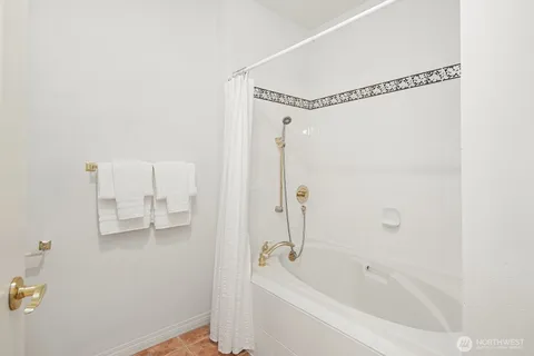 a view of a room with a sink and a mirror