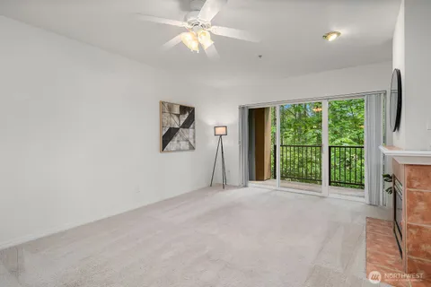 a view of an empty room with a fireplace and a large window