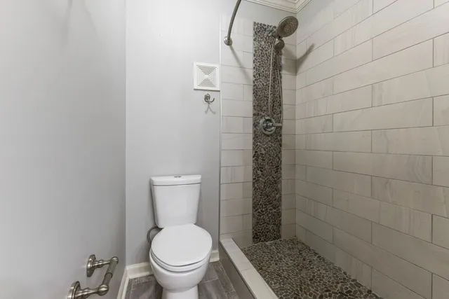 an empty room with chandelier fan