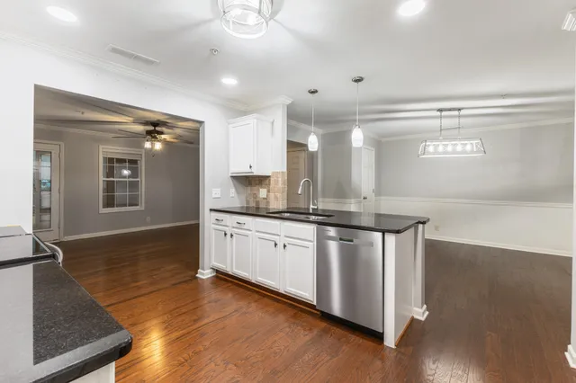 a kitchen with stainless steel appliances kitchen island granite countertop a sink refrigerator and microwave