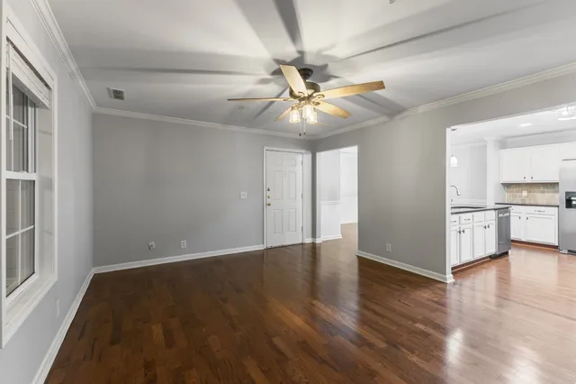 a living room with furniture a ceiling fan and a window