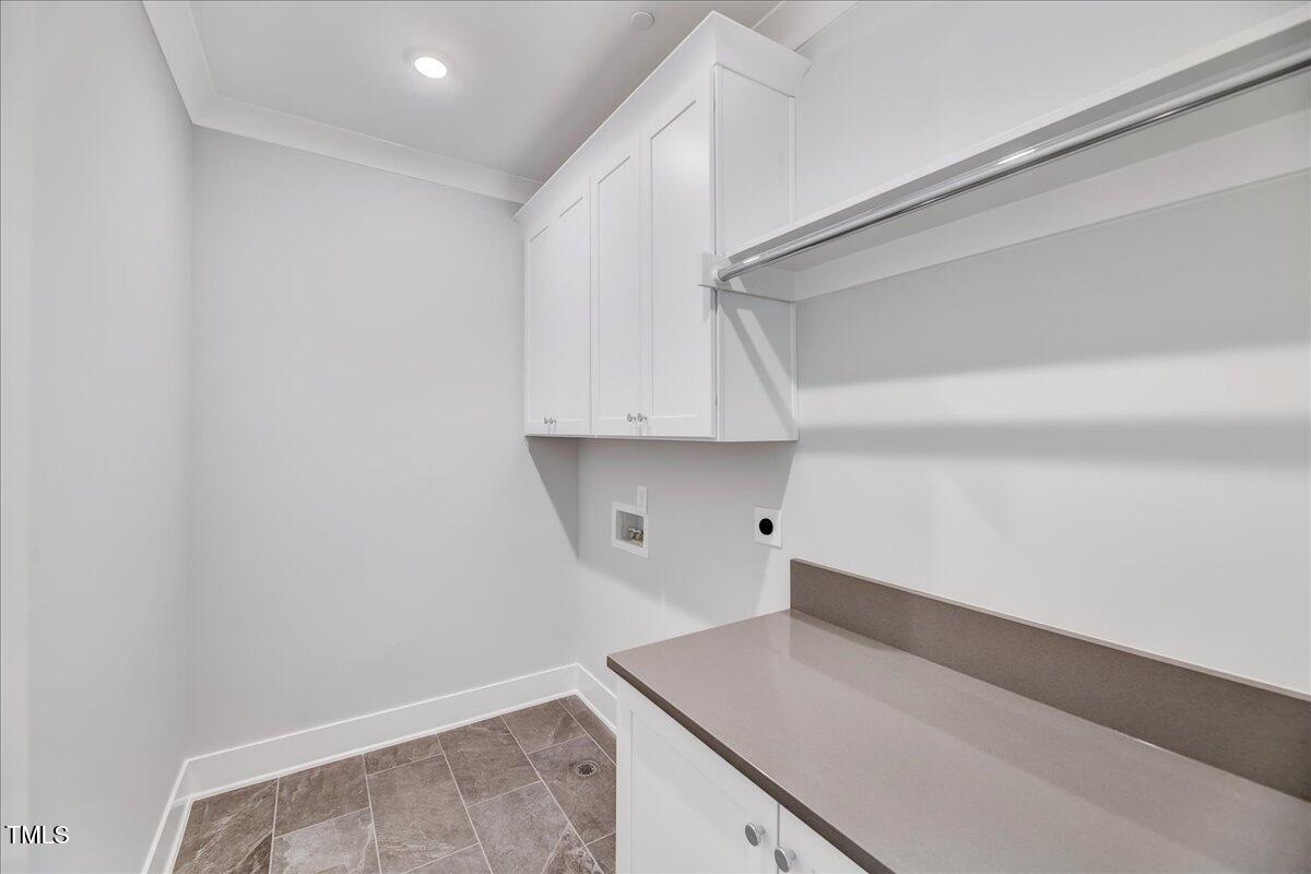 811 Maple Berry Lane, Unit 106 Raleigh, NC 27607 - Photo 16 of 30 a kitchen with white cabinets and a sink