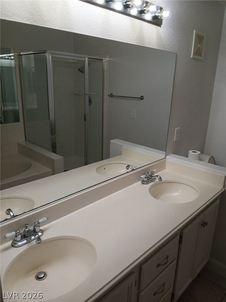 2201 Ramsgate Drive, Unit 426 Henderson, NV 89074 - Photo 11 of 22 This functional bathroom features a dual vanity and a well-appointed shower area.