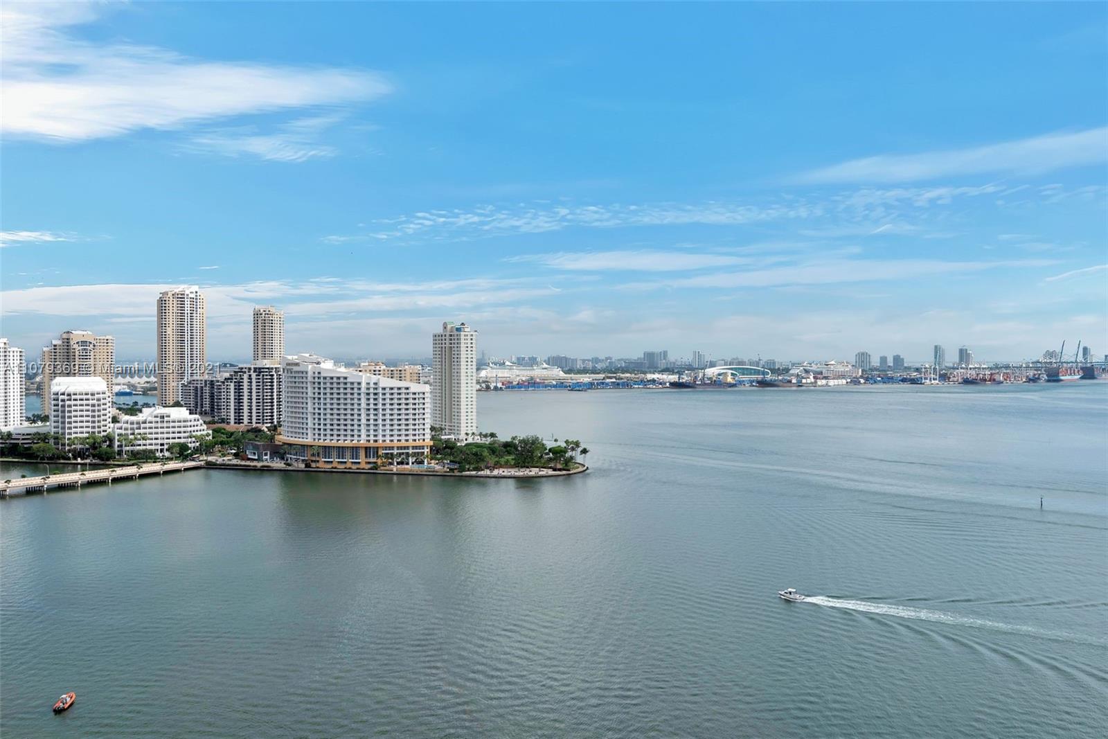 1331 Brickell Bay Drive, Unit 2401 Miami, FL 33131 - Photo 11 of 52 a view of a lake with boats and trees in the background
