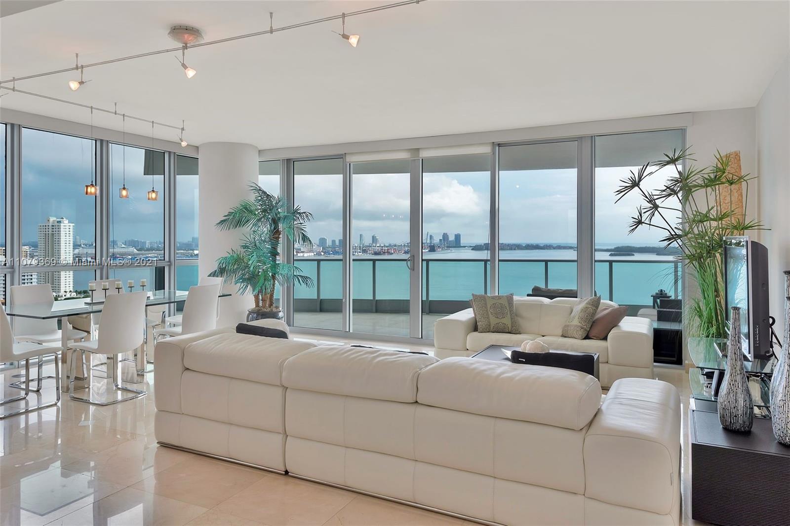 1331 Brickell Bay Drive, Unit 2401 Miami, FL 33131 - Photo 17 of 52 a living room with furniture and a large window