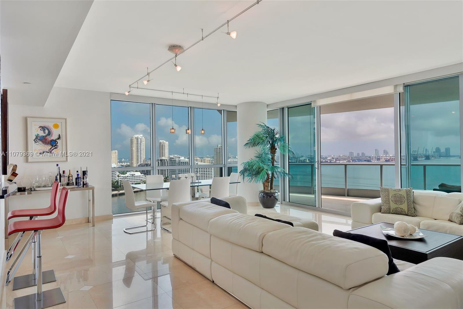 1331 Brickell Bay Drive, Unit 2401 Miami, FL 33131 - Photo 18 of 52 a living room with furniture and a large window