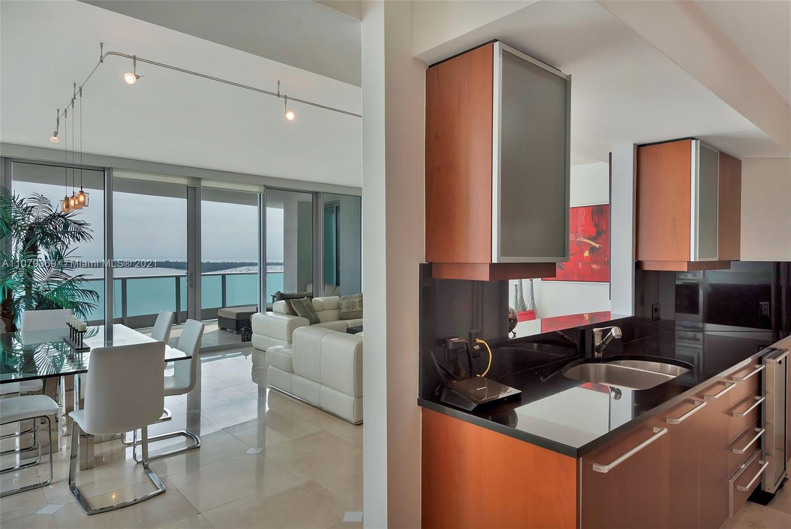 1331 Brickell Bay Drive, Unit 2401 Miami, FL 33131 - Photo 22 of 52 a kitchen with a granite countertop sink and a granite counter top