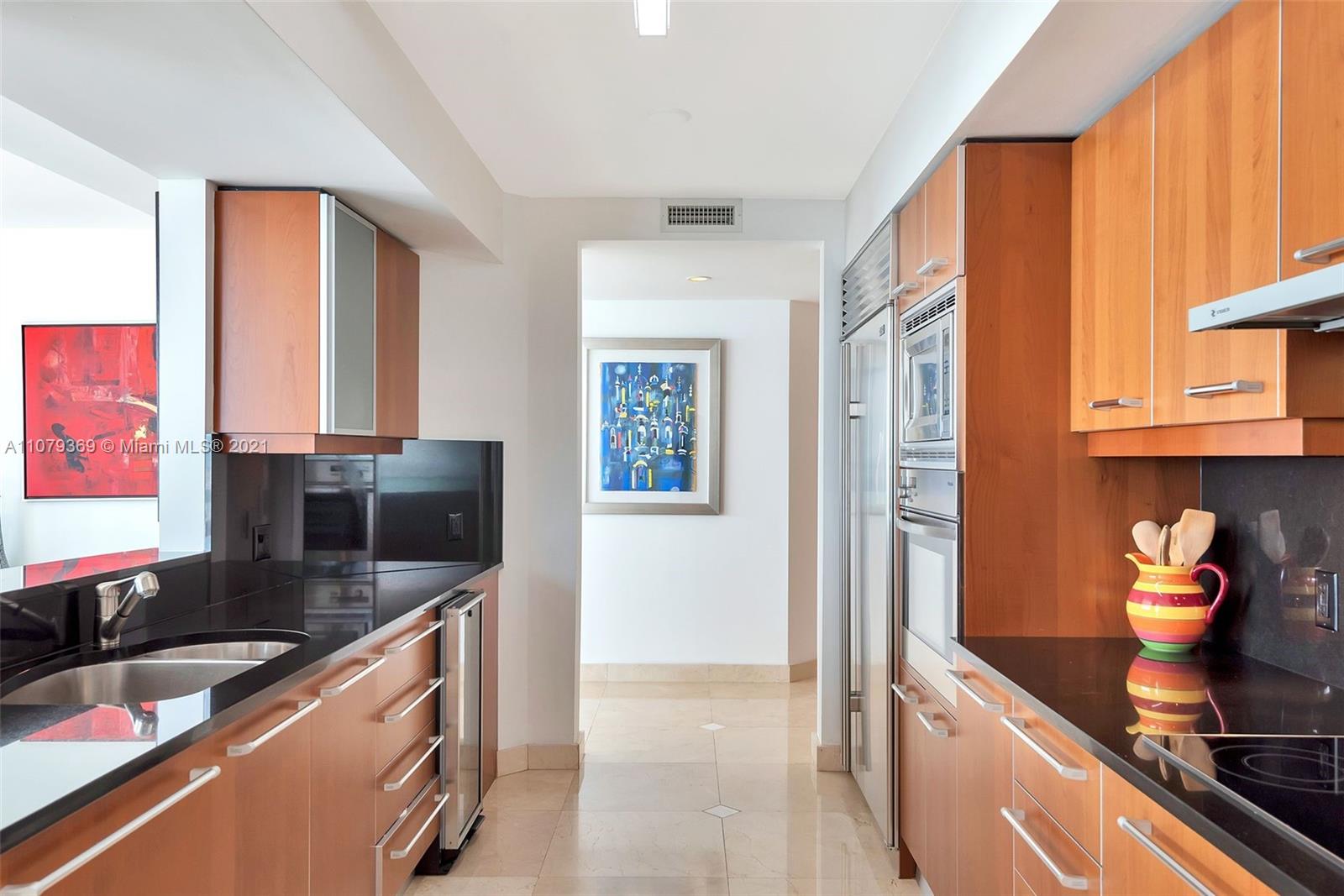 1331 Brickell Bay Drive, Unit 2401 Miami, FL 33131 - Photo 23 of 52 a kitchen with stainless steel appliances granite countertop a sink stove and refrigerator