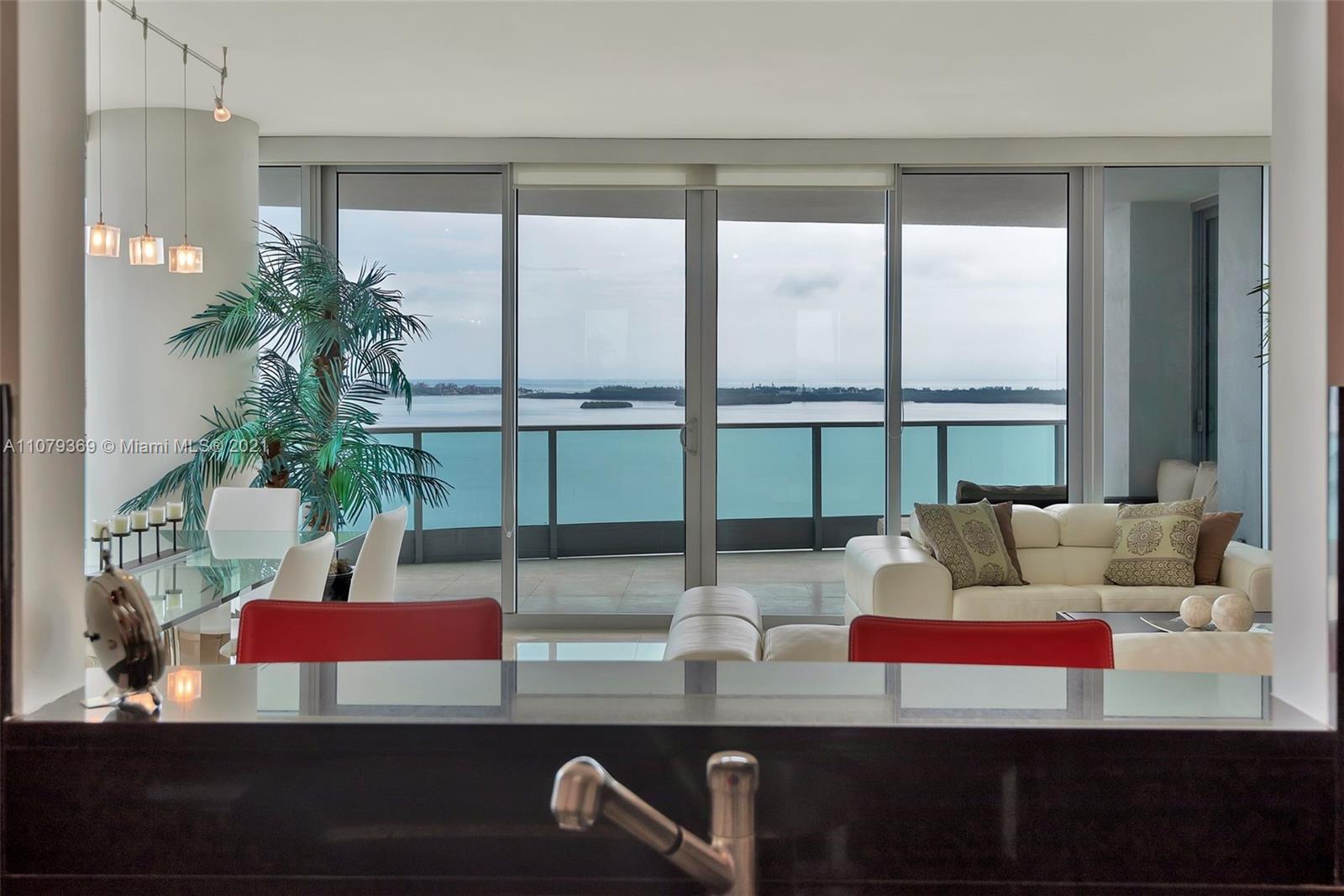 1331 Brickell Bay Drive, Unit 2401 Miami, FL 33131 - Photo 24 of 52 a living room with couches and a potted plant on the table