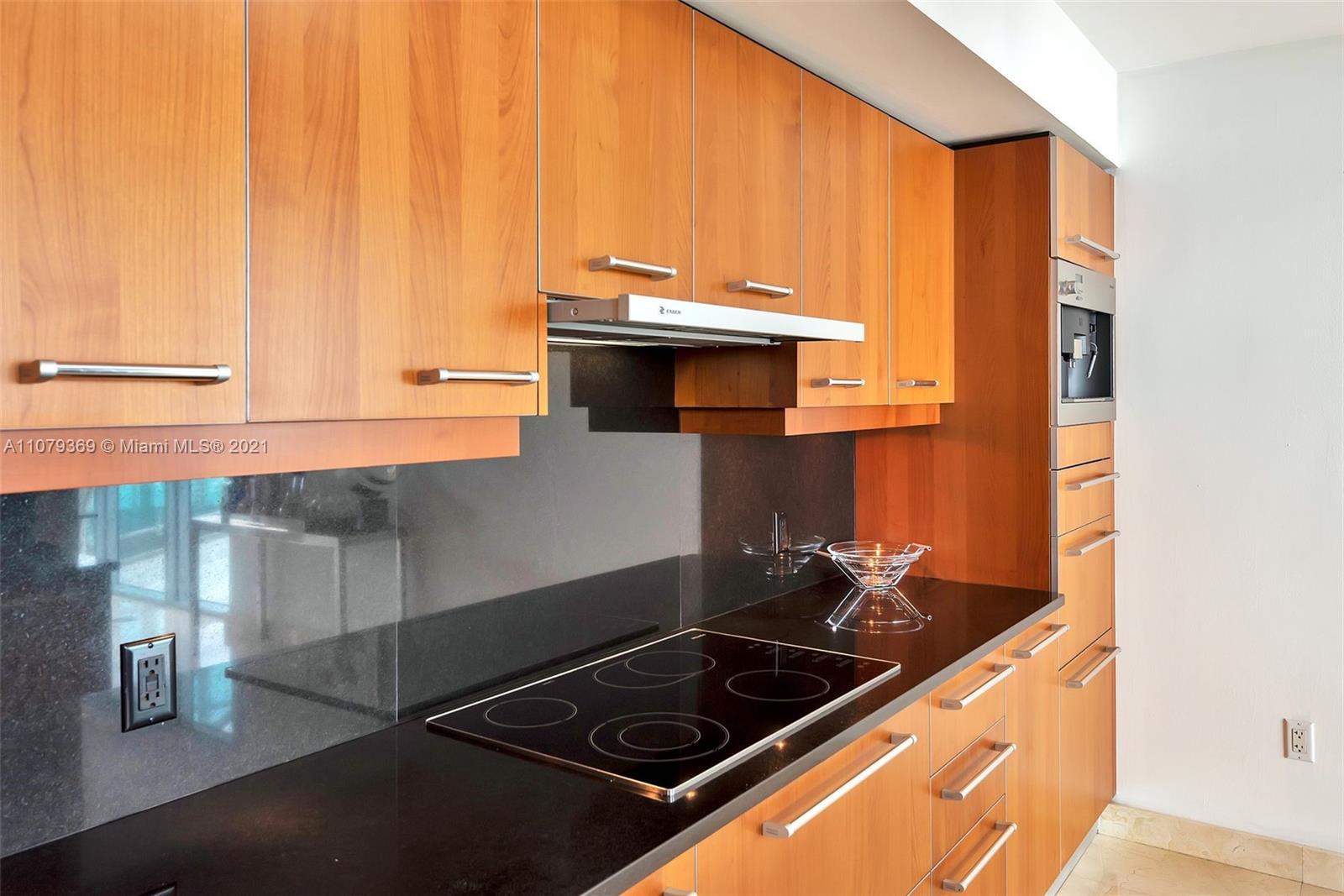 1331 Brickell Bay Drive, Unit 2401 Miami, FL 33131 - Photo 27 of 52 a stove top oven sitting inside of a kitchen