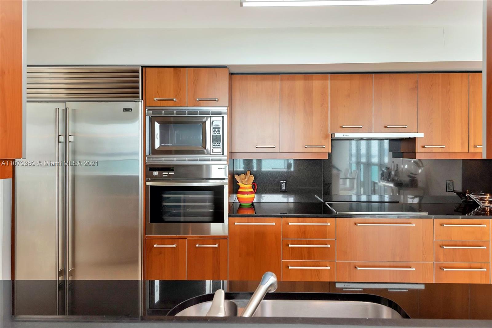 1331 Brickell Bay Drive, Unit 2401 Miami, FL 33131 - Photo 28 of 52 a kitchen with stainless steel appliances a stove and a refrigerator