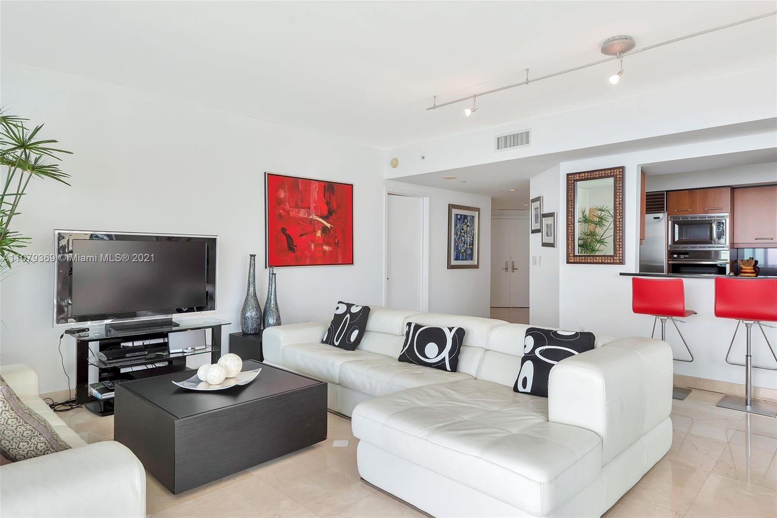 1331 Brickell Bay Drive, Unit 2401 Miami, FL 33131 - Photo 30 of 52 a living room with furniture and a flat screen tv