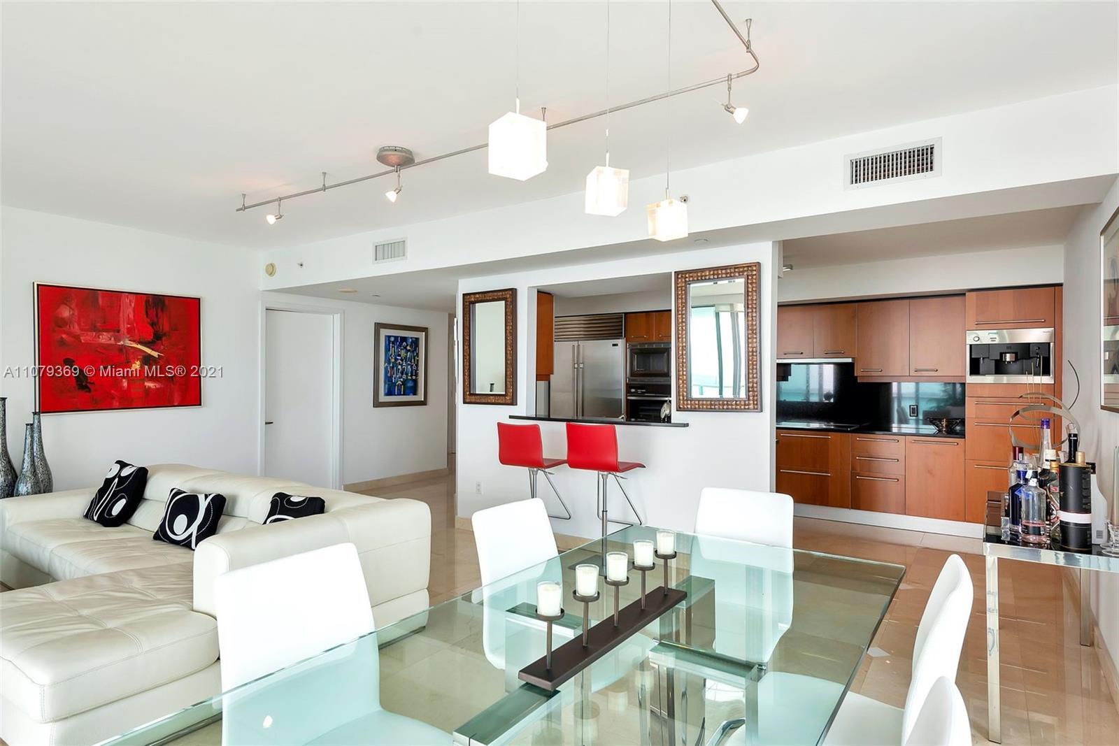 1331 Brickell Bay Drive, Unit 2401 Miami, FL 33131 - Photo 31 of 52 a living room with furniture and wooden floor