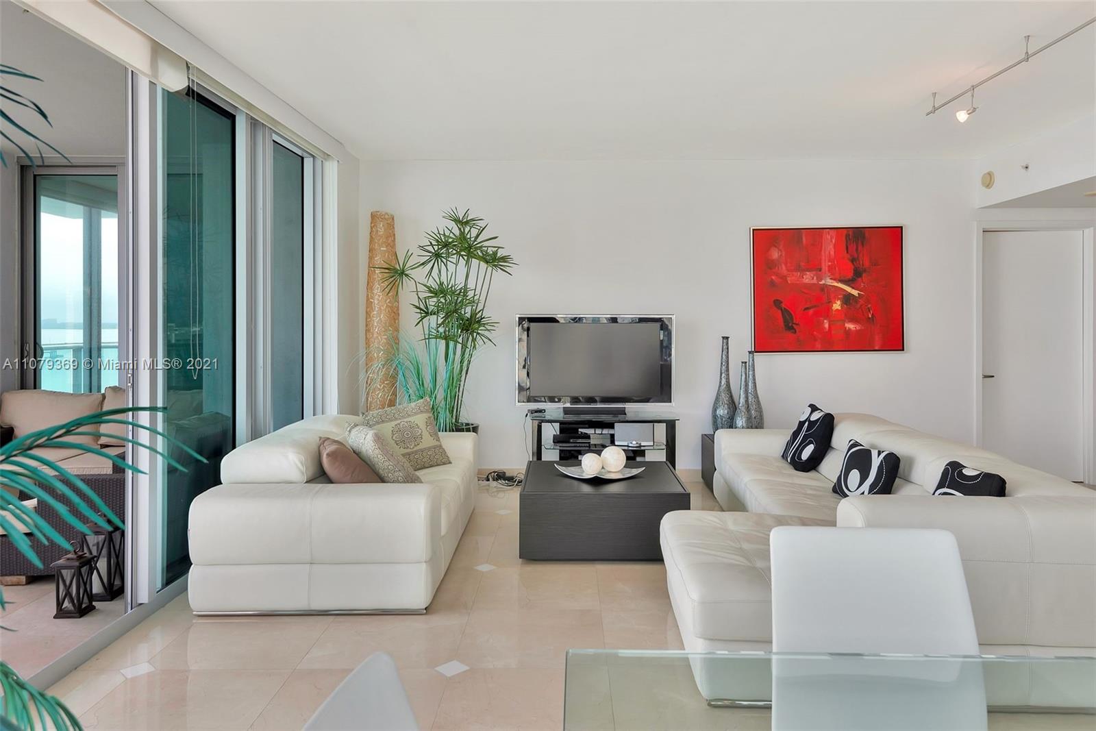 1331 Brickell Bay Drive, Unit 2401 Miami, FL 33131 - Photo 32 of 52 a living room with furniture and a flat screen tv