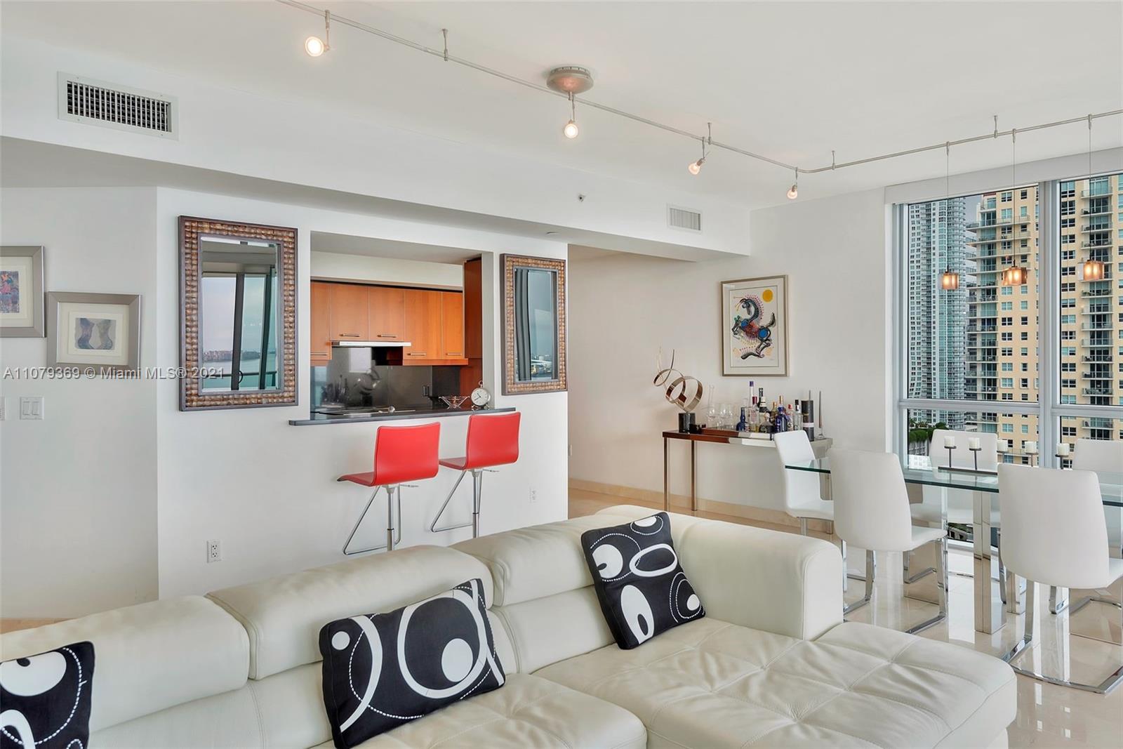 1331 Brickell Bay Drive, Unit 2401 Miami, FL 33131 - Photo 33 of 52 a living room with furniture and a window