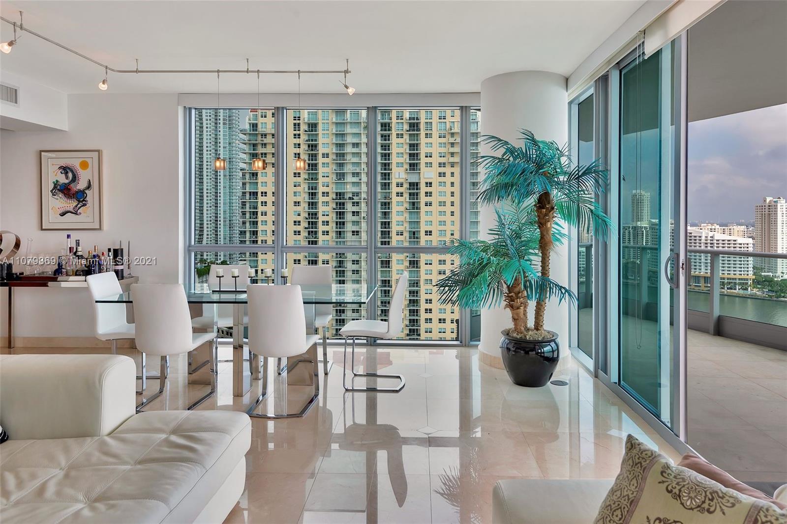 1331 Brickell Bay Drive, Unit 2401 Miami, FL 33131 - Photo 34 of 52 a living room with furniture and a floor to ceiling window