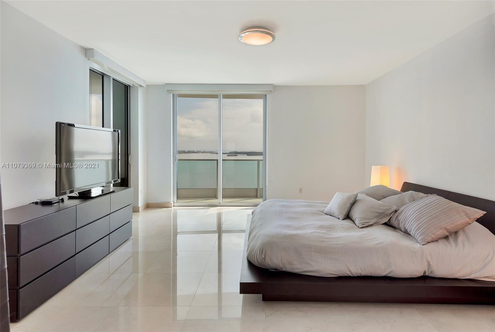 1331 Brickell Bay Drive, Unit 2401 Miami, FL 33131 - Photo 37 of 52 a bedroom with a bed and a flat screen tv